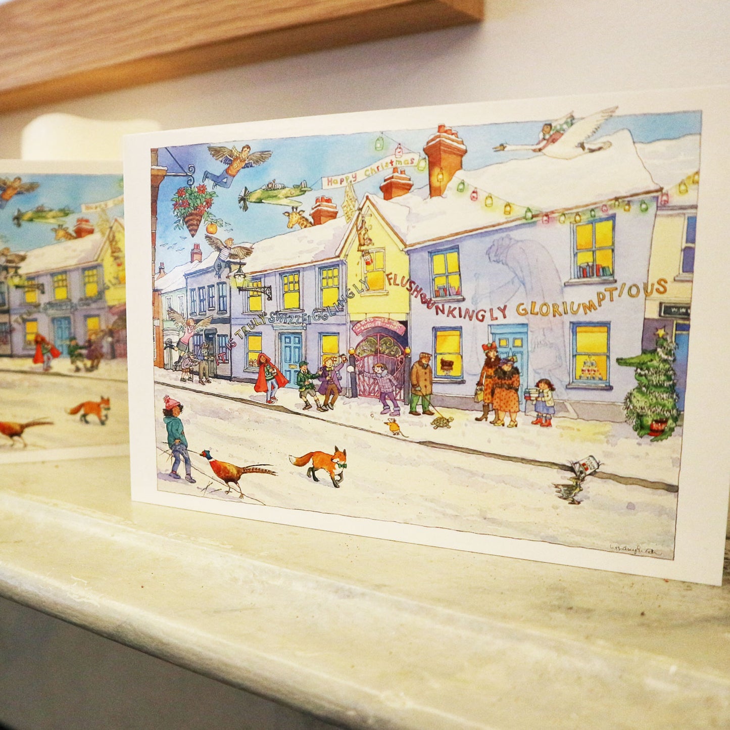 Christmas card with illustration of the Roald Dahl Museum and Story Centre winter scene
